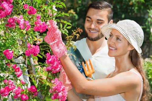 Operatives trimming hedges with protective gear